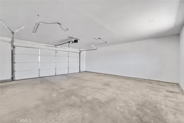 a view of a dry yard with wooden fence