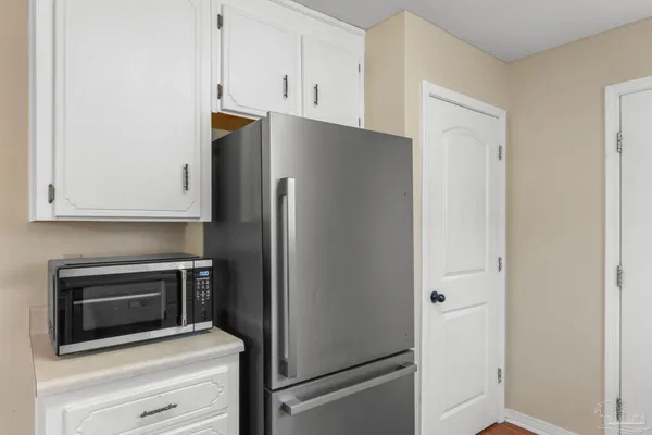 a kitchen with cabinets and stainless steel appliances