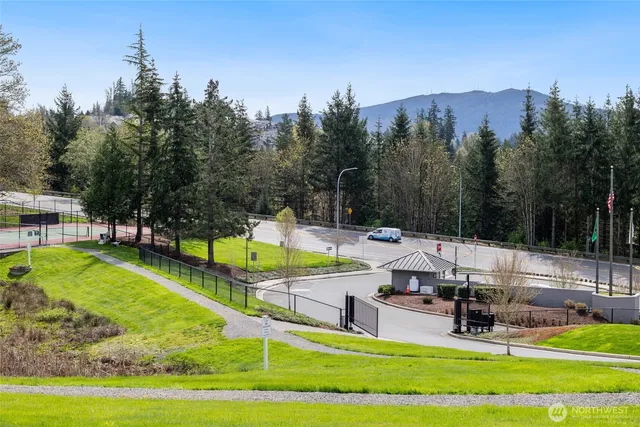 a view of a swimming pool with a patio and a yard