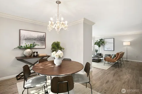 a view of a dining room with furniture and chandelier