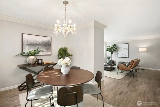 a view of a dining room with furniture and chandelier