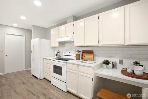 a kitchen with stainless steel appliances white cabinets and a sink