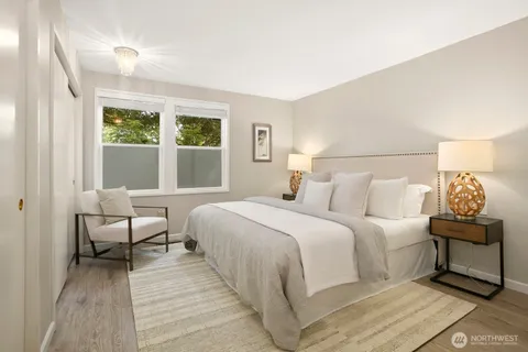 a bedroom with a bed and a large window