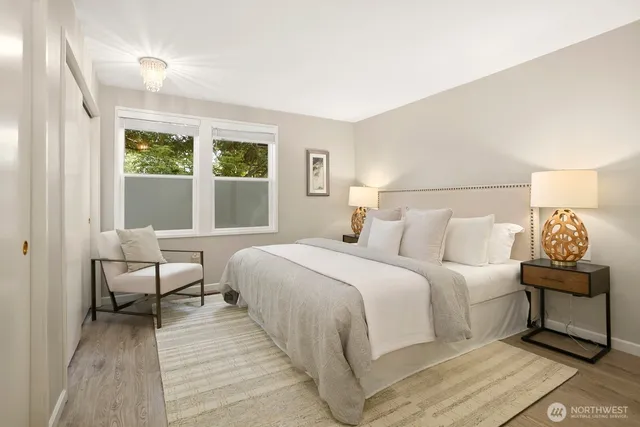 a bedroom with a bed and a large window