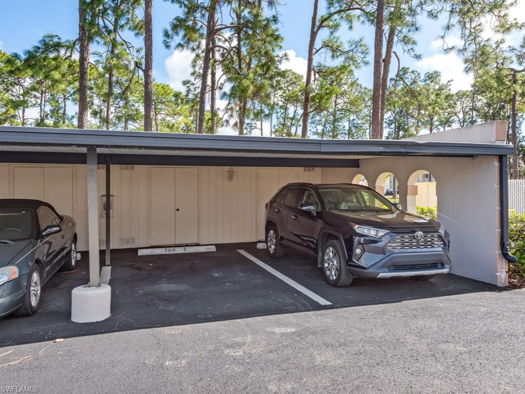 709 Augusta Boulevard, Unit 7095 Naples, FL 34113 - Photo 14 of 16 View of parking / parking lot with a carport