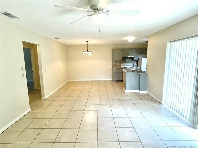 a view of a kitchen with a sink and a refrigerator