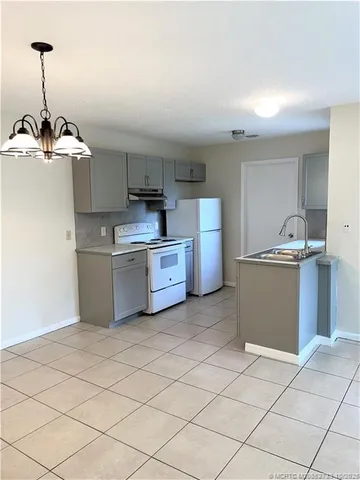 a kitchen with stainless steel appliances a sink and a refrigerator