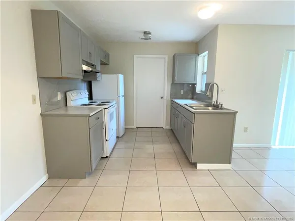 a kitchen with stainless steel appliances a stove top oven and cabinets