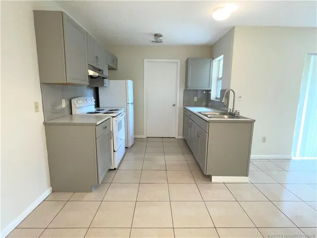a kitchen with stainless steel appliances a stove top oven and cabinets