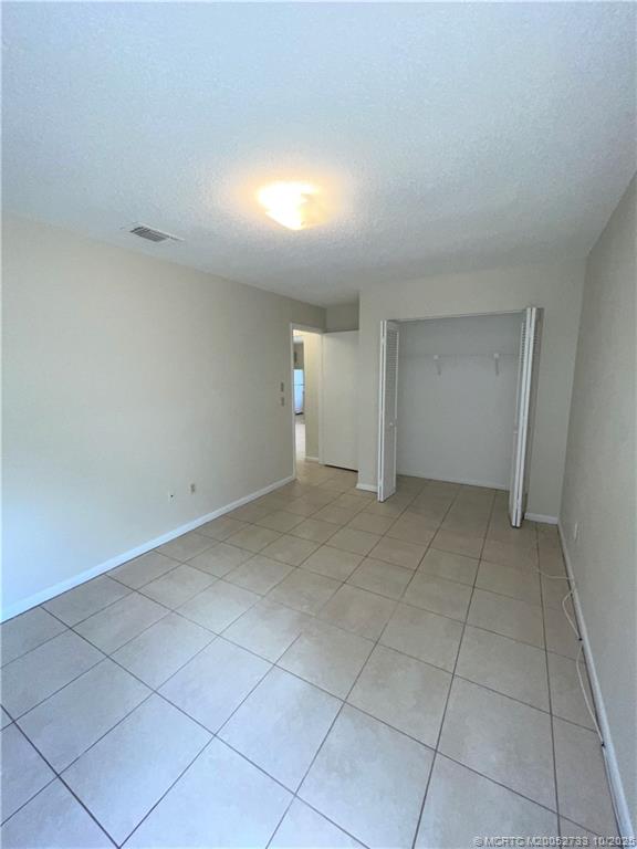 402 South 14th Street, Unit B Fort Pierce, FL 34950 - Photo 8 of 9 a view of an empty room with a window