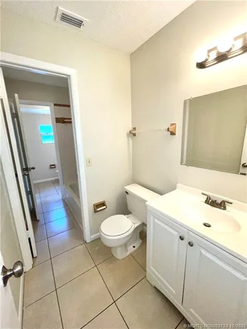a bathroom with a sink and mirror with toilet
