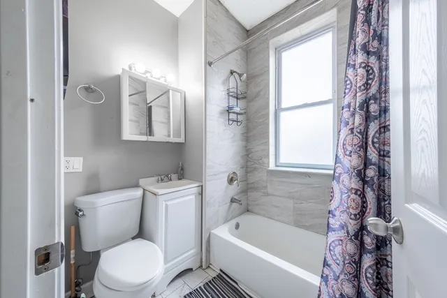 a white toilet sitting next to a bath tub