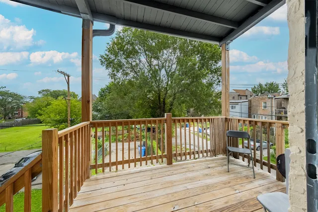a view of a deck with wooden floor and outdoor seating