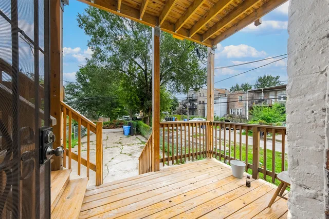 a view of a balcony with wooden floor