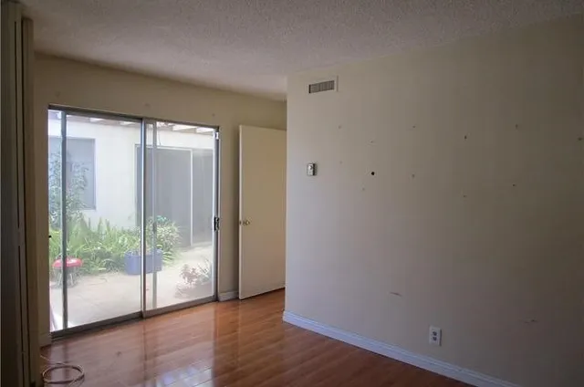 a view of wooden floor and windows in a room