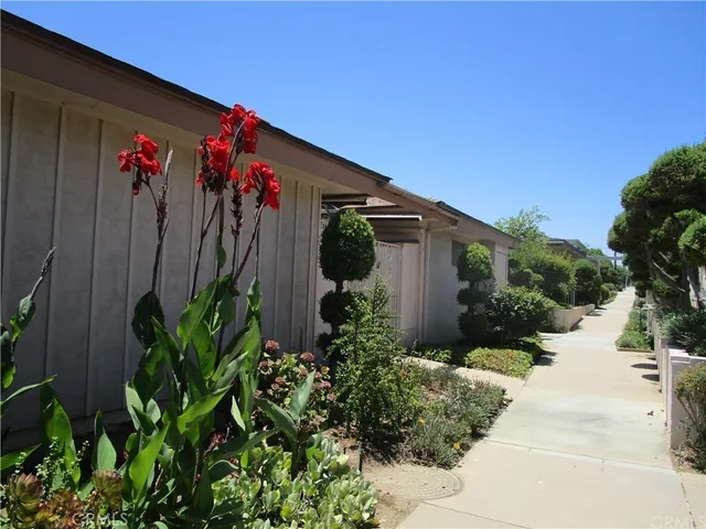a front view of a house with a flower garden