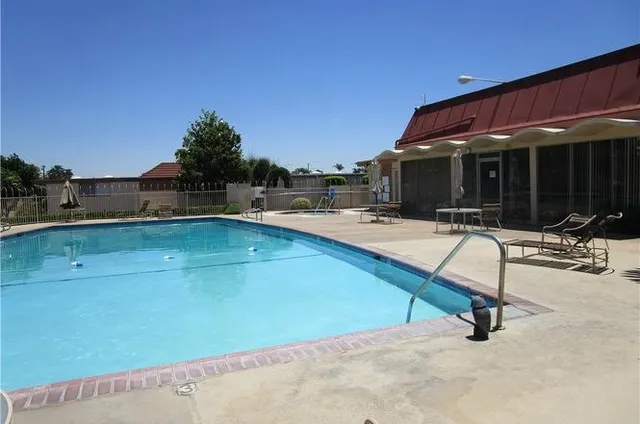 a view of a swimming pool with a lounge chair