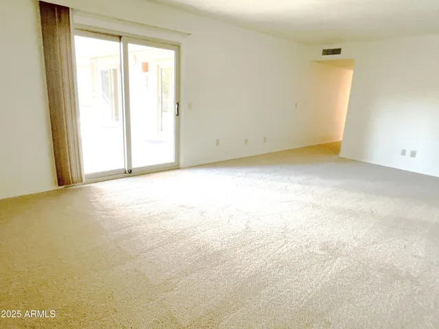 a view of an empty room and a window