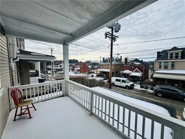 a view of a chairs and table in the balcony