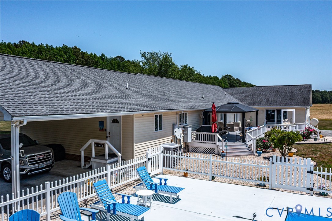 4400 Hacks Neck Road Heathsville, VA 22473 - Photo 57 of 78 a view of a patio with couches table and chairs with wooden fence