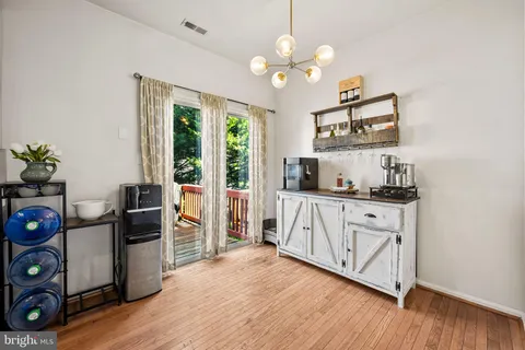 a very nice looking room with wooden floor and a window