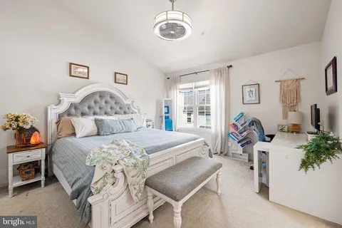 a bedroom with a bed and potted plant