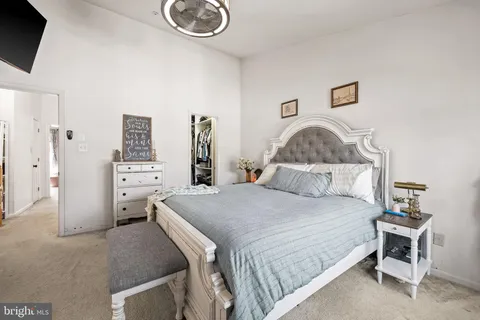 a bedroom with a bed and a flat tv screen