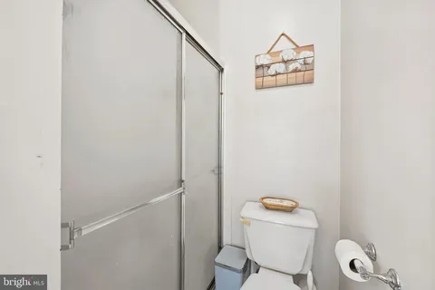 a bathroom with a toilet and a shower