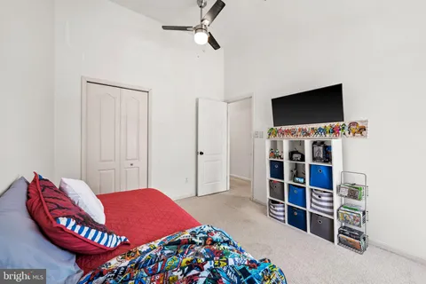 a bedroom with a bed and a bookshelf