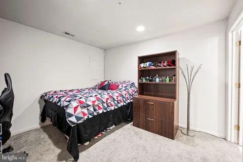 a bedroom with a bed and cabinets