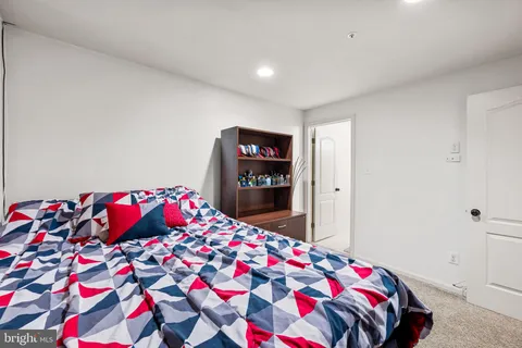 a bedroom with bed and a mirror