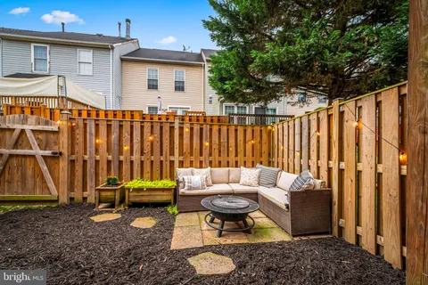 a backyard of a house with barbeque oven table and chairs