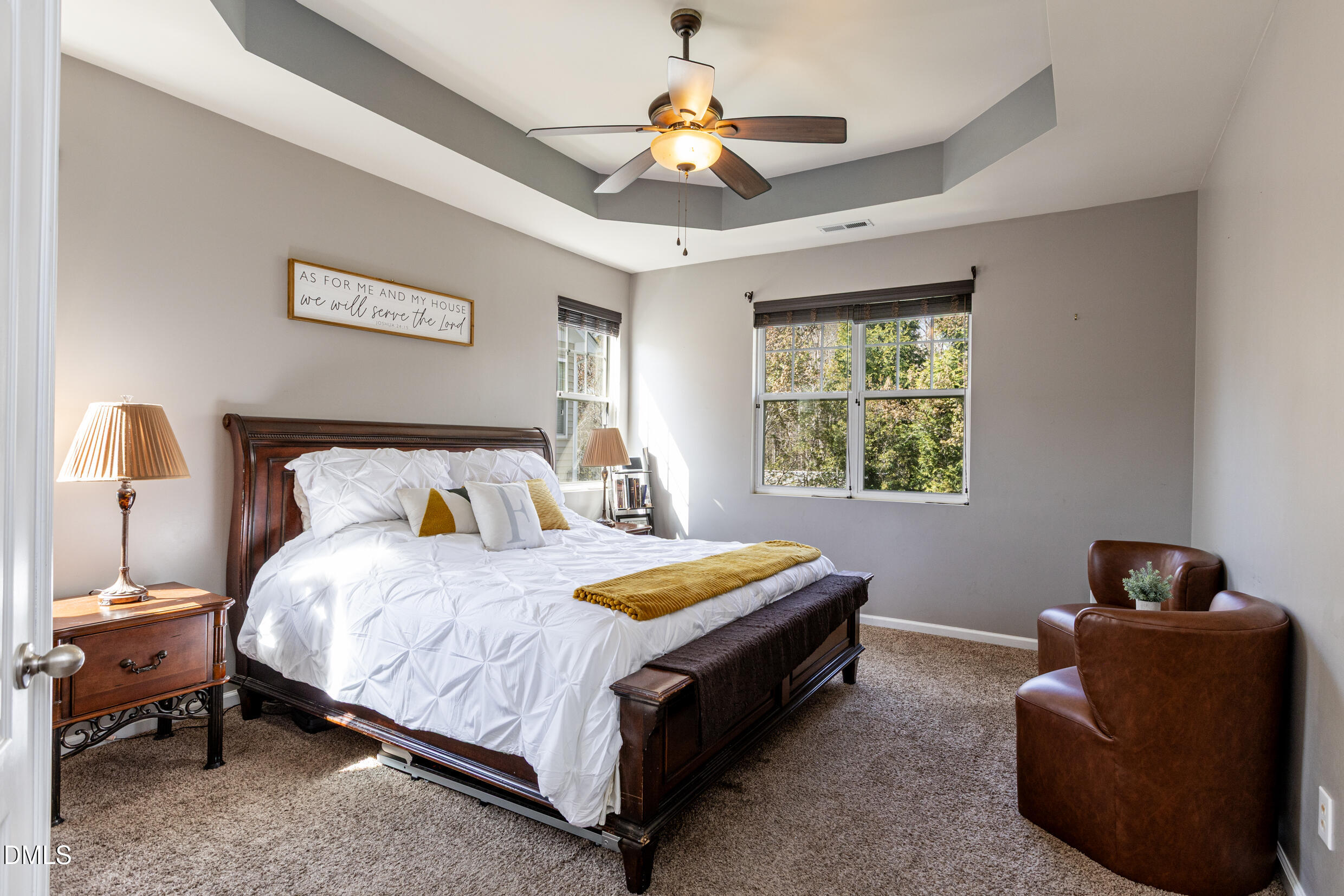 7250 Terregles Drive Raleigh, NC 27617 - Photo 13 of 19 a bedroom with a bed and a chandelier