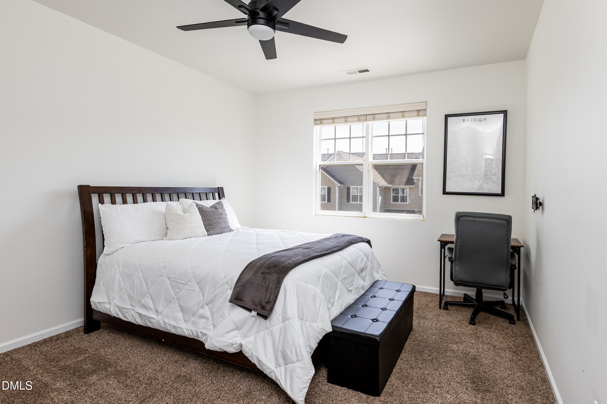 7250 Terregles Drive Raleigh, NC 27617 - Photo 14 of 19 a bedroom with a bed a desk and chair with window