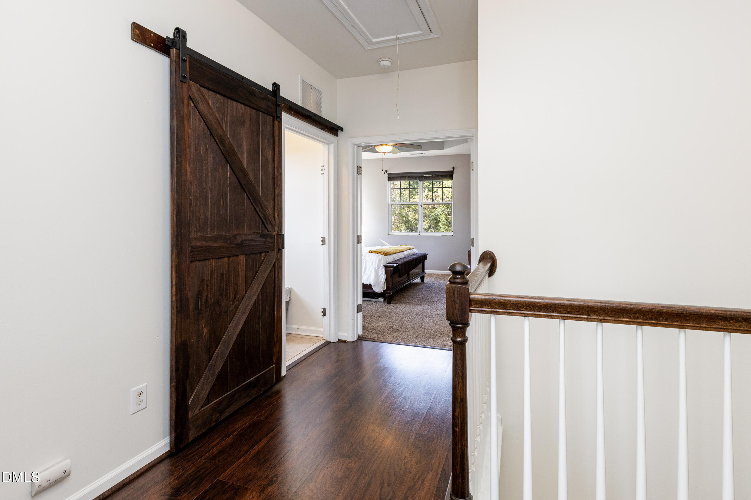 7250 Terregles Drive Raleigh, NC 27617 - Photo 16 of 19 a view of a hallway with wooden floor and staircase