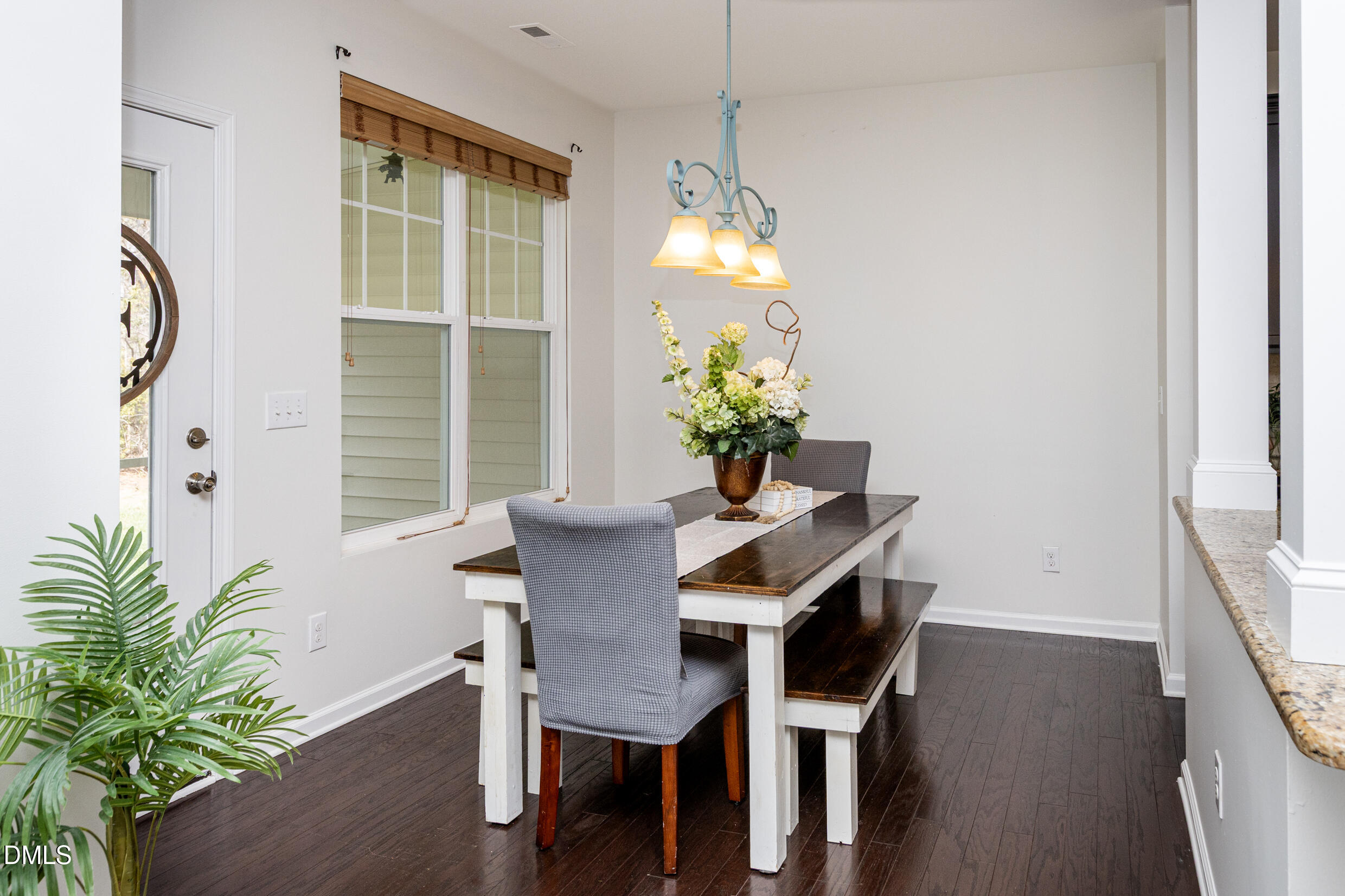 7250 Terregles Drive Raleigh, NC 27617 - Photo 6 of 19 a dining room with furniture potted plants and wooden floor