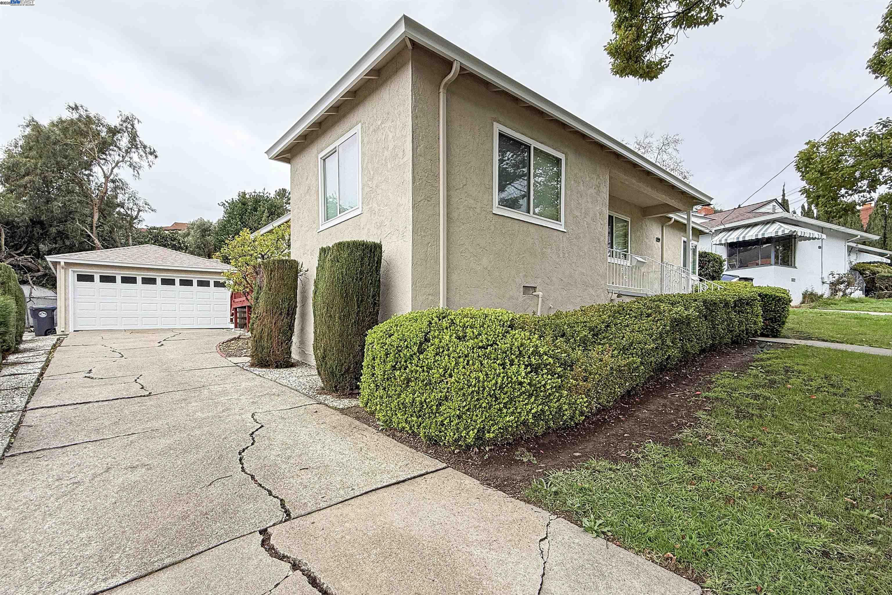 1516 Grove Way Hayward, CA 94546 - Photo 2 of 39 a front view of a house with garden