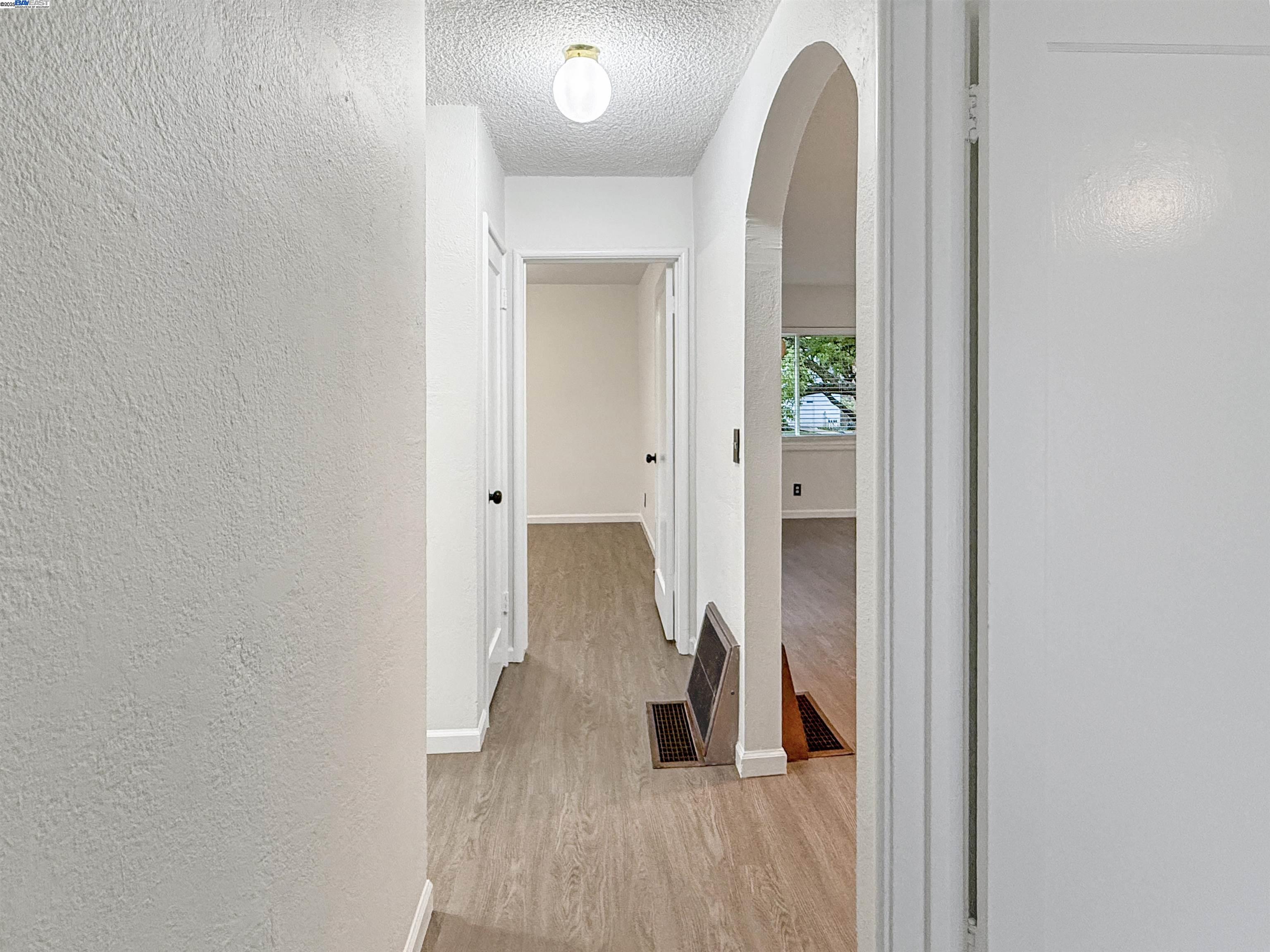 1516 Grove Way Hayward, CA 94546 - Photo 25 of 39 a view of a hallway with wooden floor and a bathroom