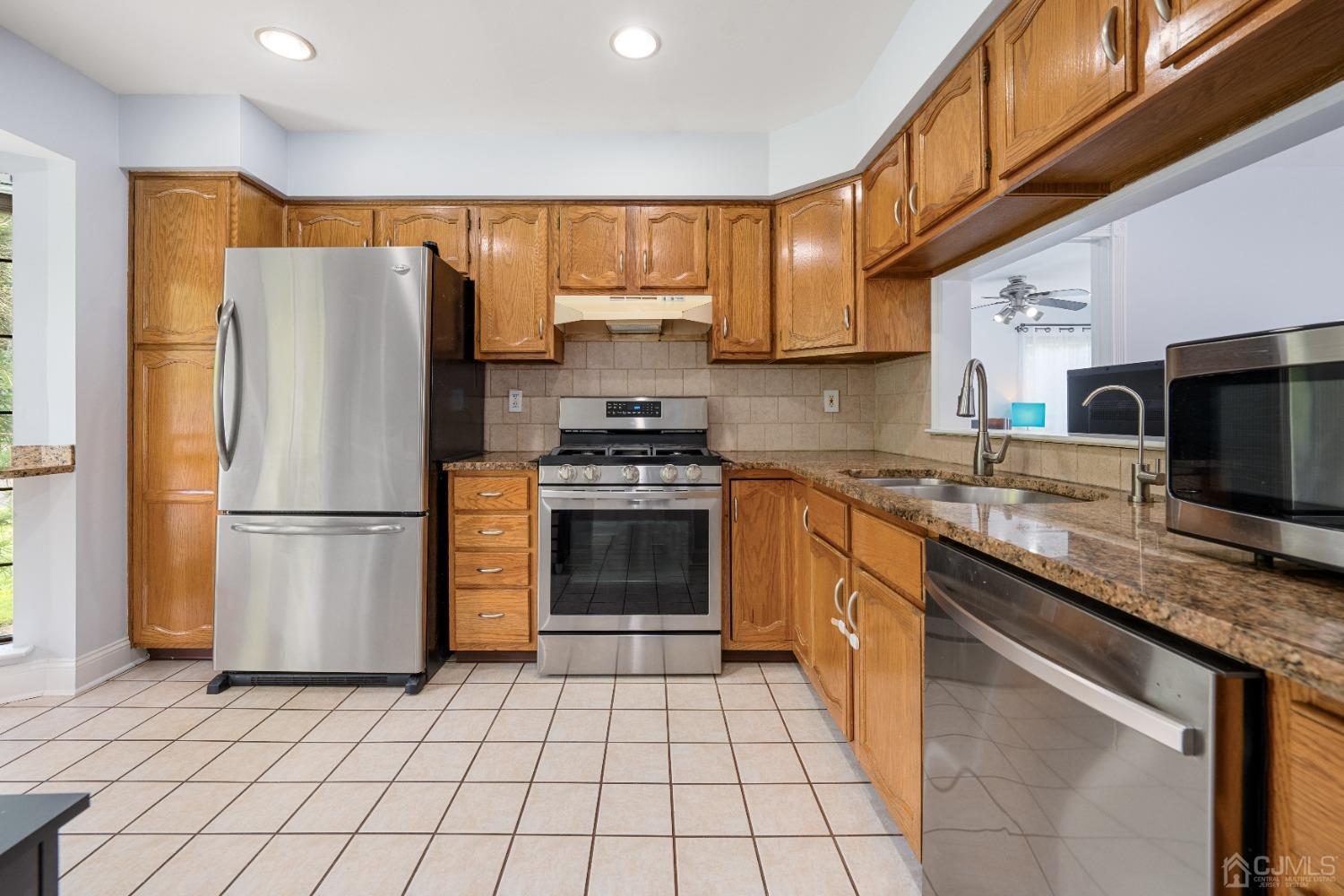 1501 Timber Oaks Road Edison, NJ 08820 - Photo 6 of 17 a kitchen with stainless steel appliances granite countertop a refrigerator stove top oven a sink and dishwasher