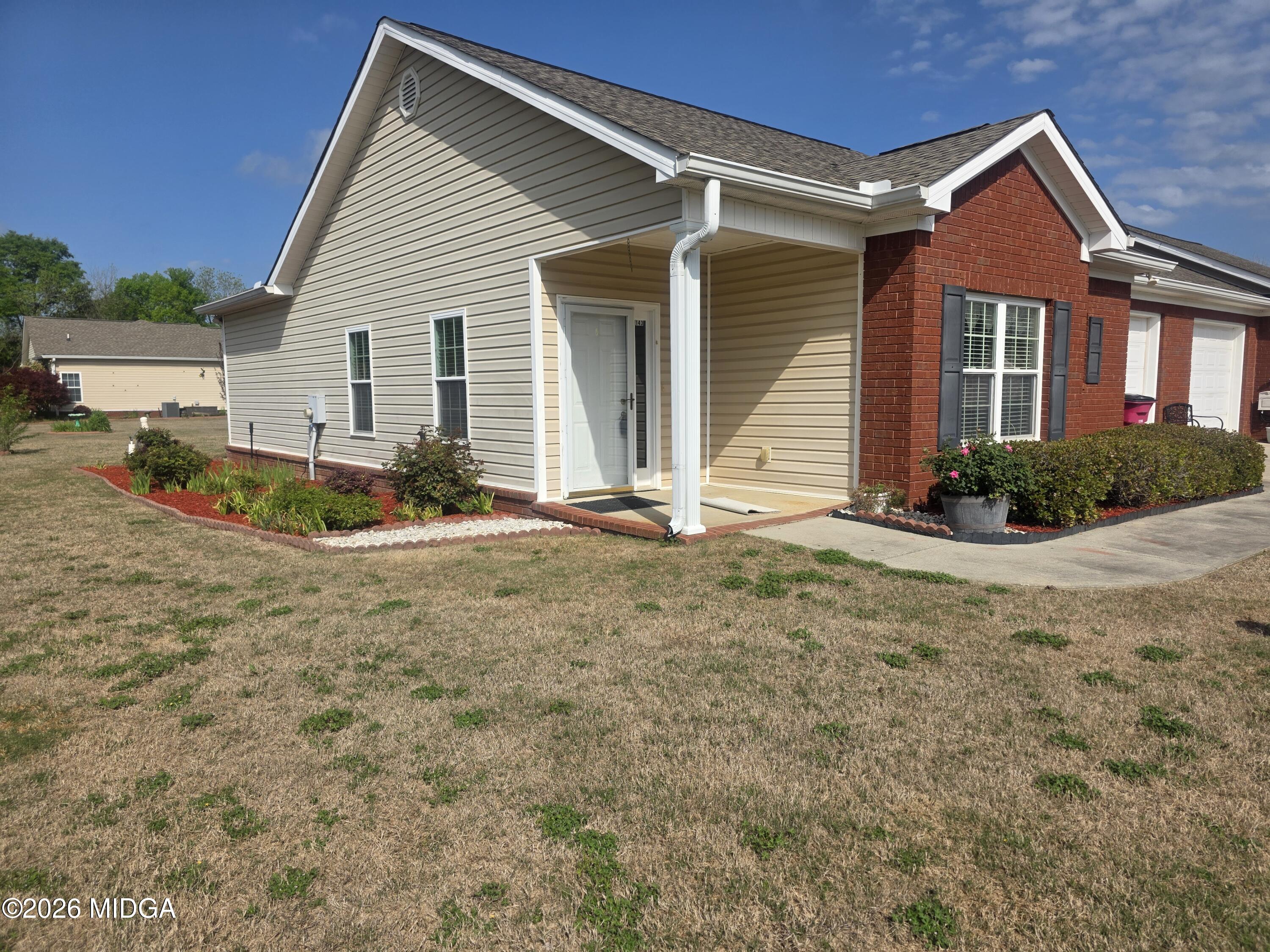 a front view of a house with garden