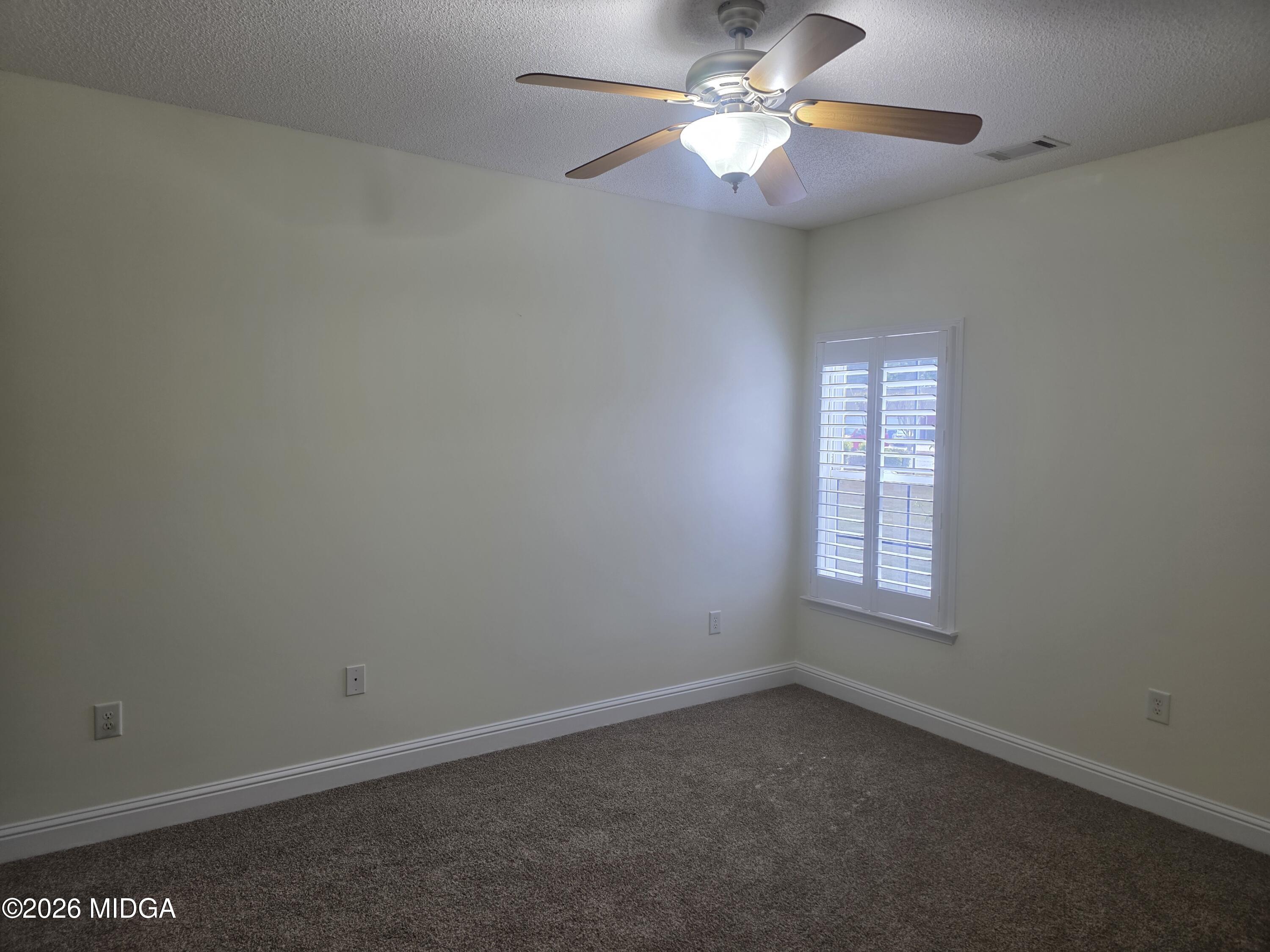 143 Jabrok Circle Macon, GA 31216 - Photo 9 of 15 an empty room with a window and a fan