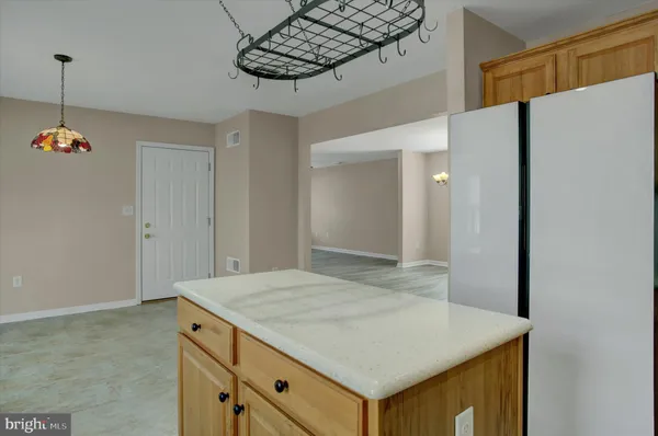a view of kitchen cabinets and microwave