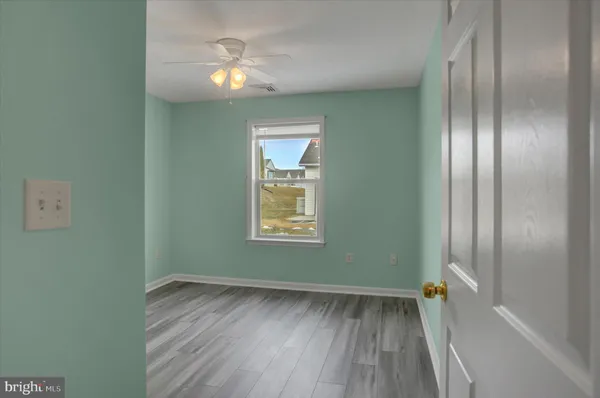 a view of room with window and hardwood floor
