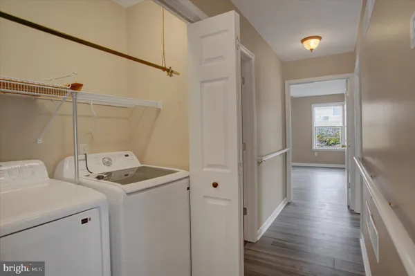 a view of a hallway with washer and dryer