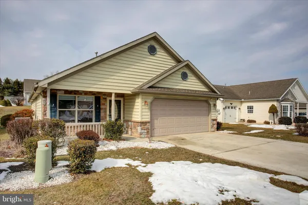 a view of a house with a yard covered in snow