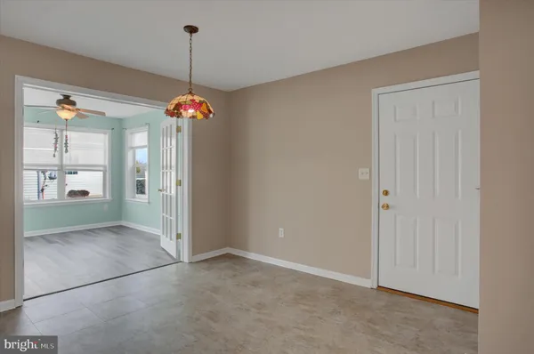 a view of a room with window and kitchen view