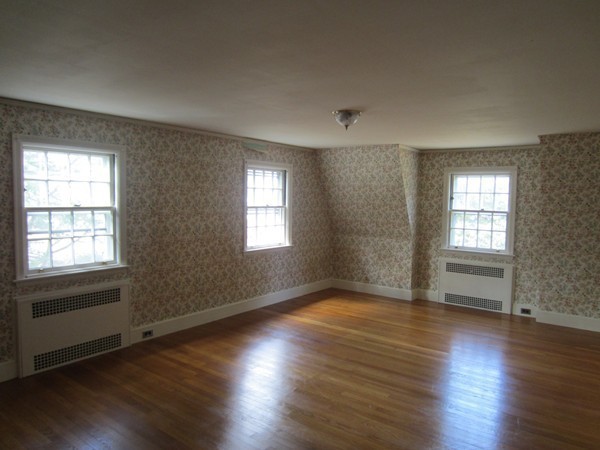 61 Denton Road Wellesley, MA 02482 - Photo 11 of 16 an empty room with wooden floor and windows