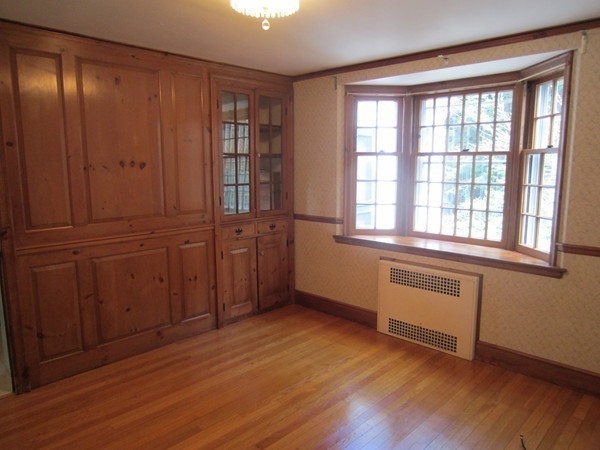 61 Denton Road Wellesley, MA 02482 - Photo 9 of 16 an empty room with wooden floor and windows