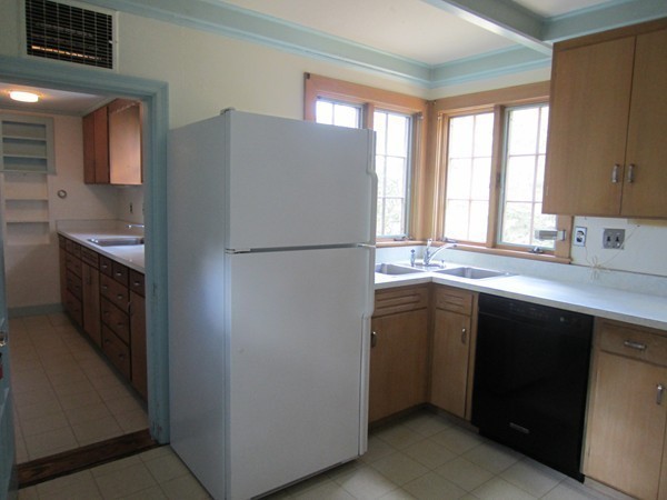 61 Denton Road Wellesley, MA 02482 - Photo 10 of 16 a kitchen with a refrigerator sink and cabinets