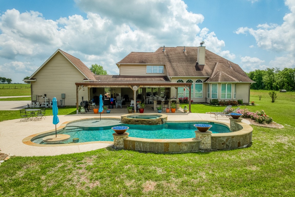 4701 Cedar Hill Road Brenham, TX 77833 - Photo 14 of 50 a view of a house with swimming pool and a yard